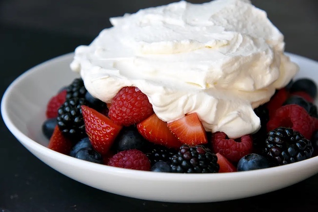 Berries with whipped cream in a bowl